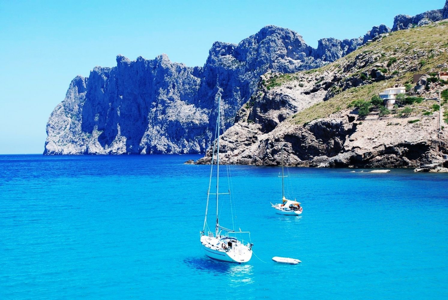 Sailboat in turquoise water off Palma de Mallorca