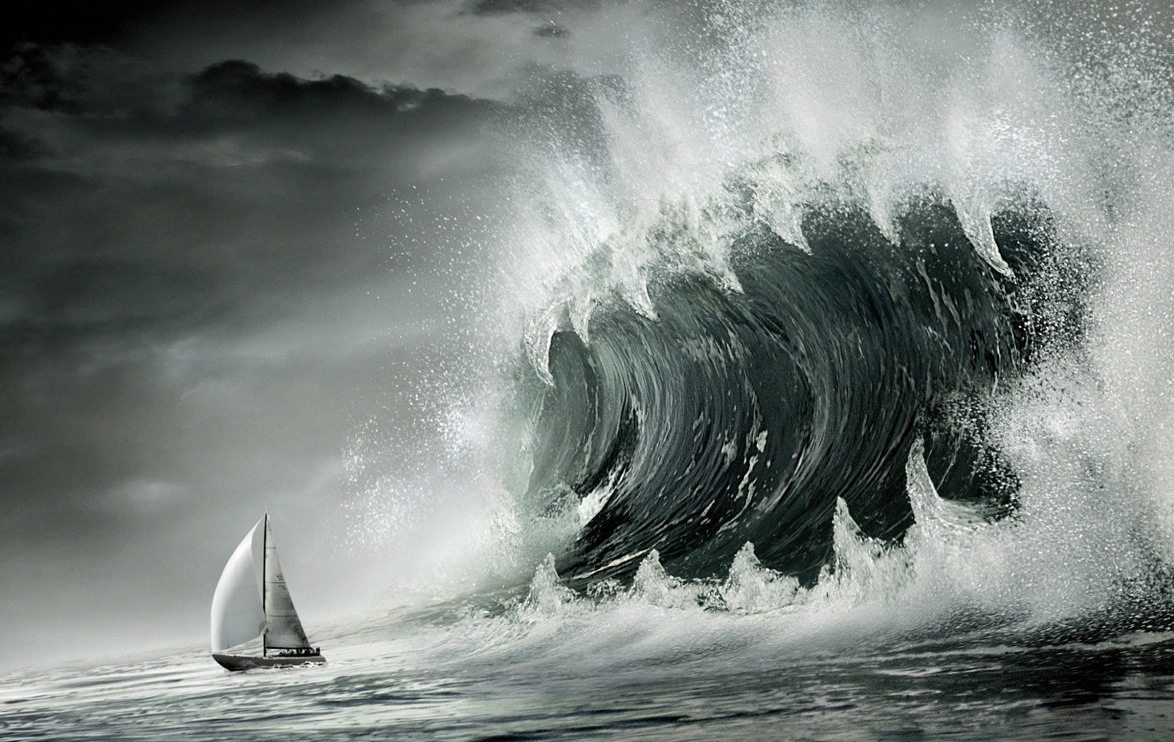 Huge wave about to crash into a sailboat