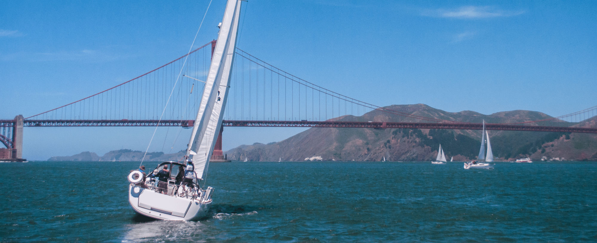 Well-trimmed sailboat heading for the Golden Gate bridge