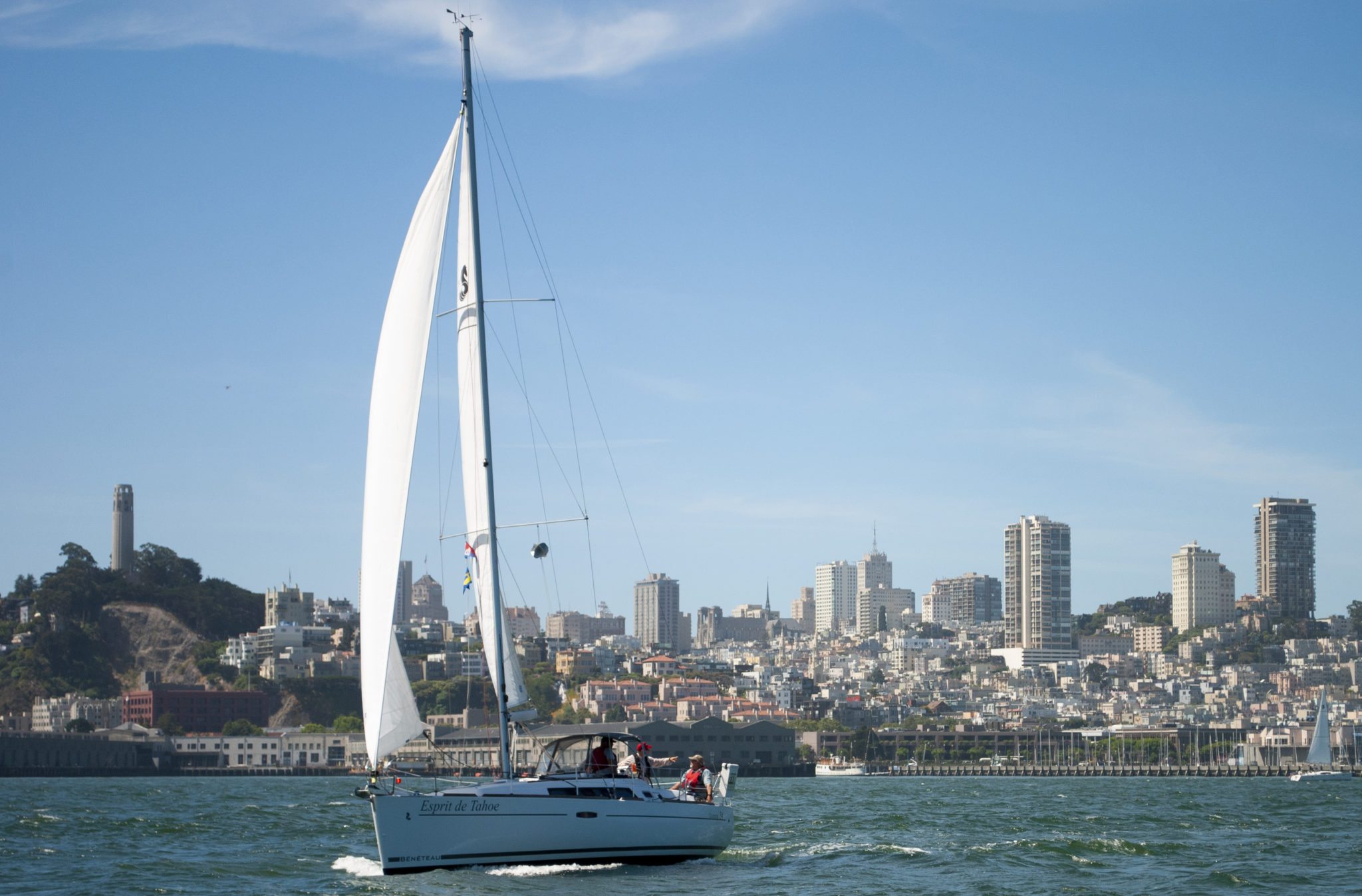sailboat moving swiftly past the San Francisco skyline