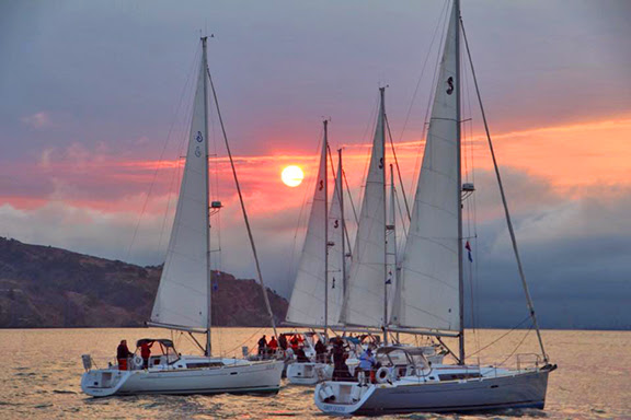 Four sailboats at sunset